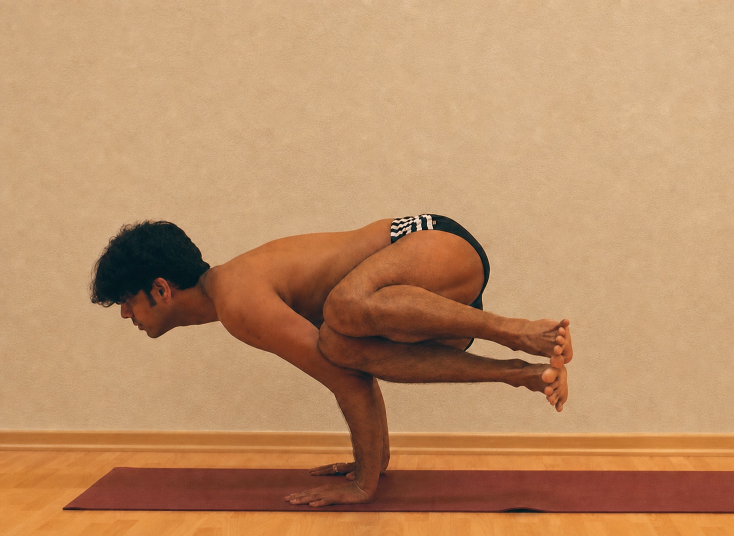 Parsva Bakasana yoga practice demonstrated by Pankaj